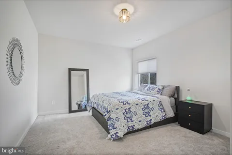 a spacious bathroom with a double vanity sink a mirror and a bathtub