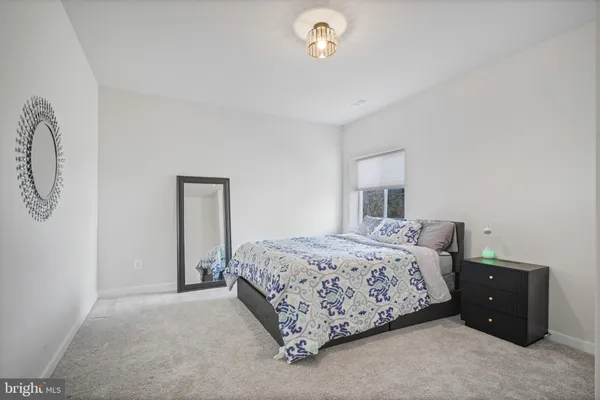 a spacious bathroom with a double vanity sink a mirror and a bathtub