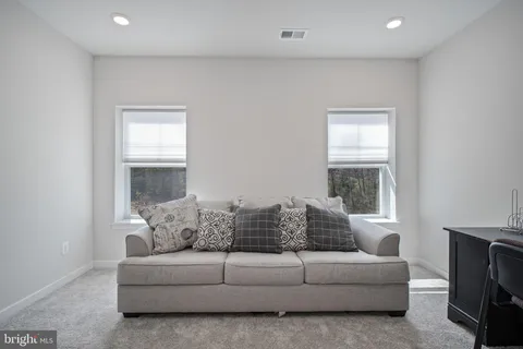 a bedroom with a large bed and a flat screen tv