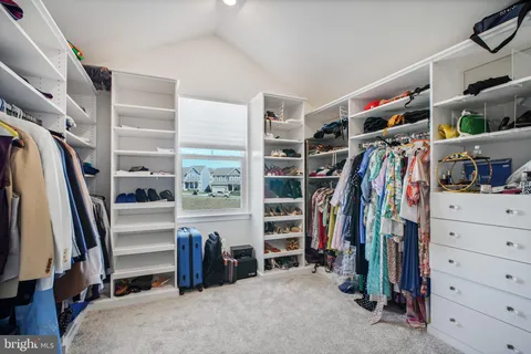 a bedroom with furniture and a flat screen tv