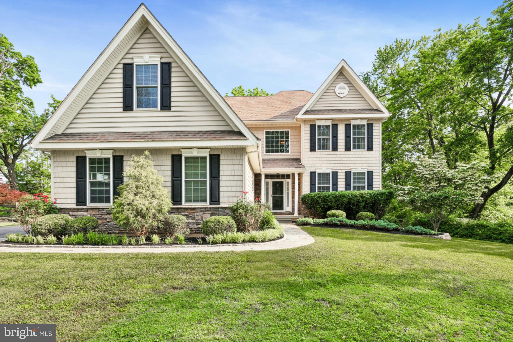a front view of a house with a yard and potted plants