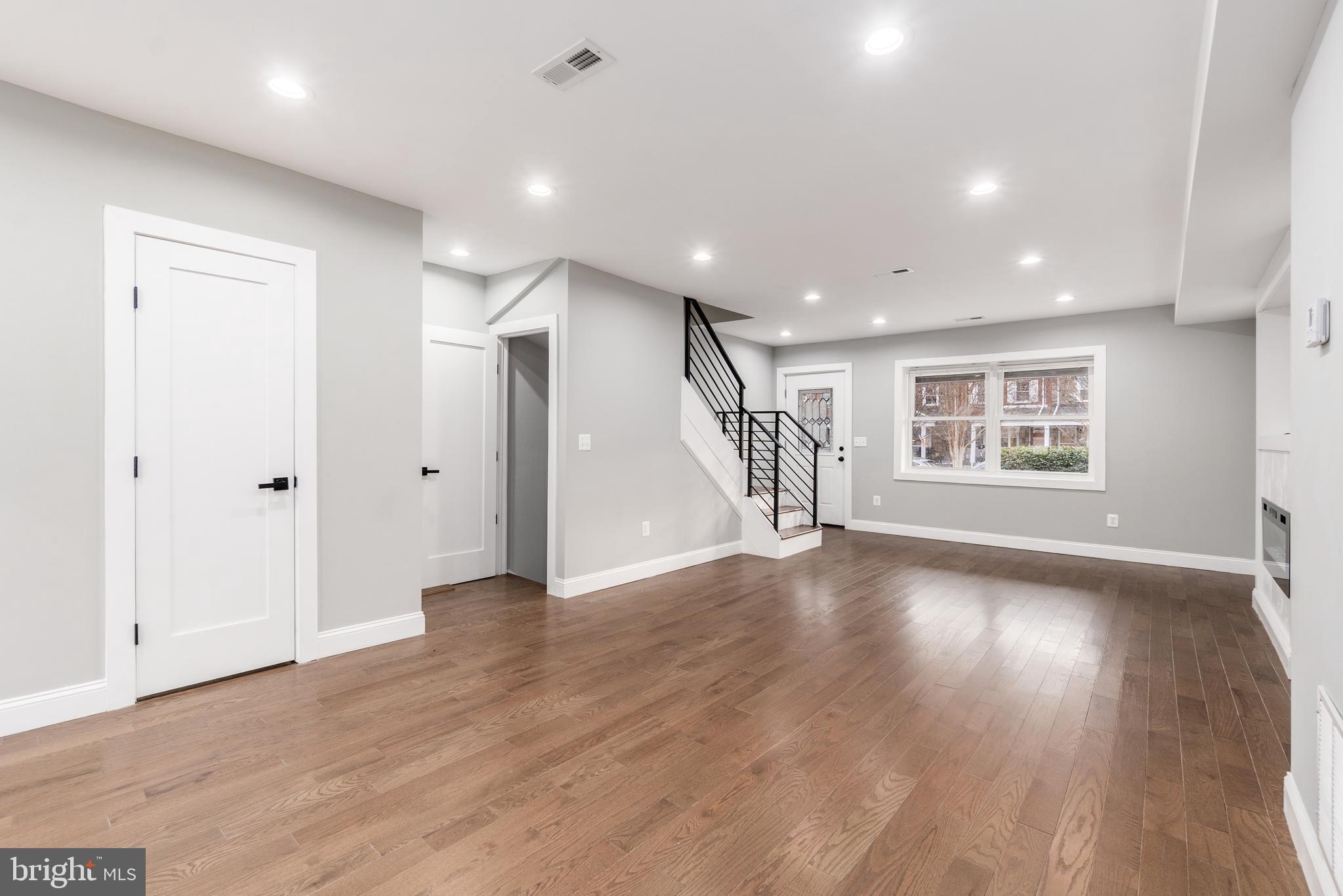 928 Perry Place Northeast Washington, DC 20017 - Photo 13 of 36 a view of an empty room with wooden floor and a window