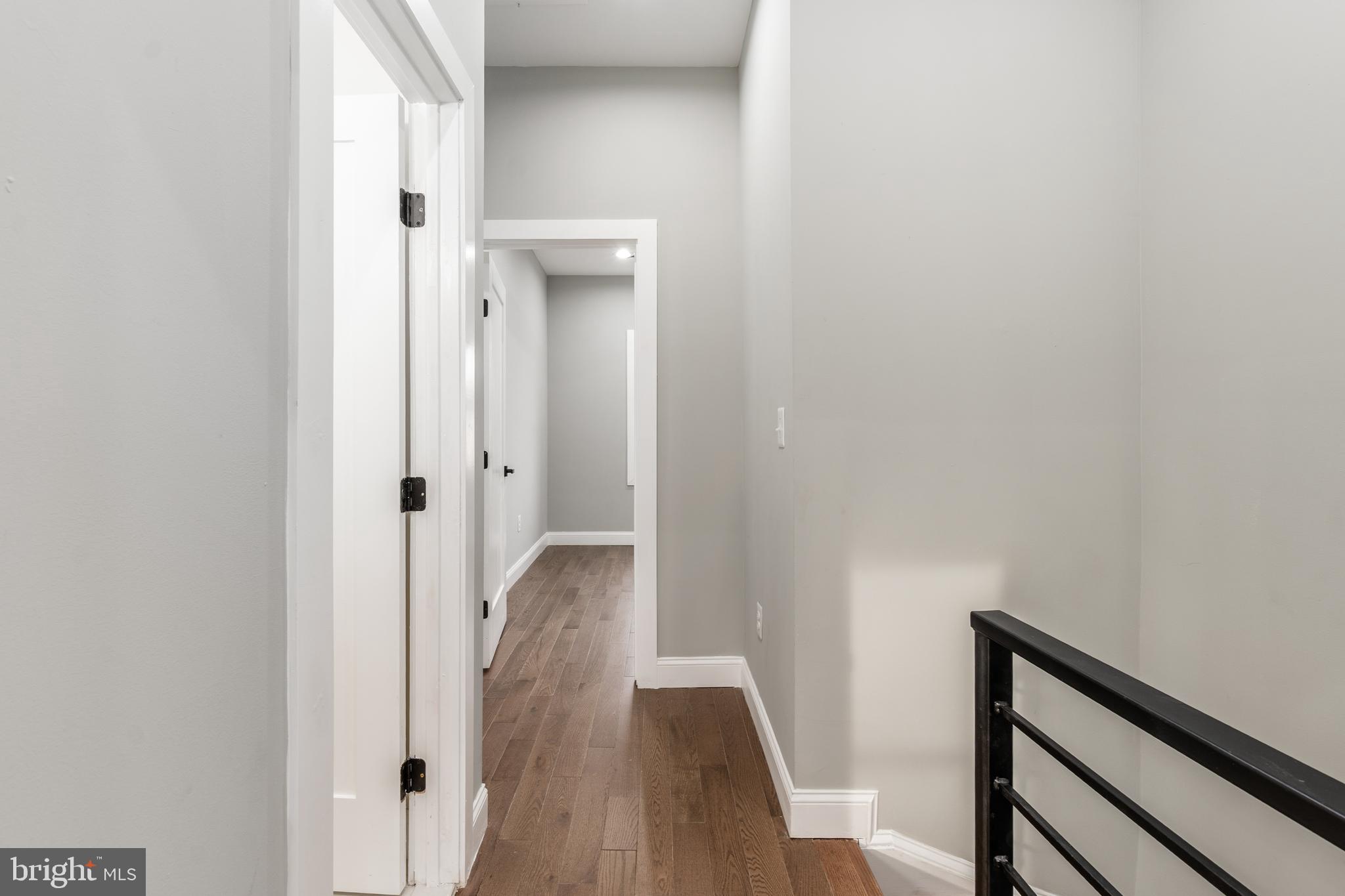 928 Perry Place Northeast Washington, DC 20017 - Photo 15 of 36 a view of a hallway with wooden floor and staircase