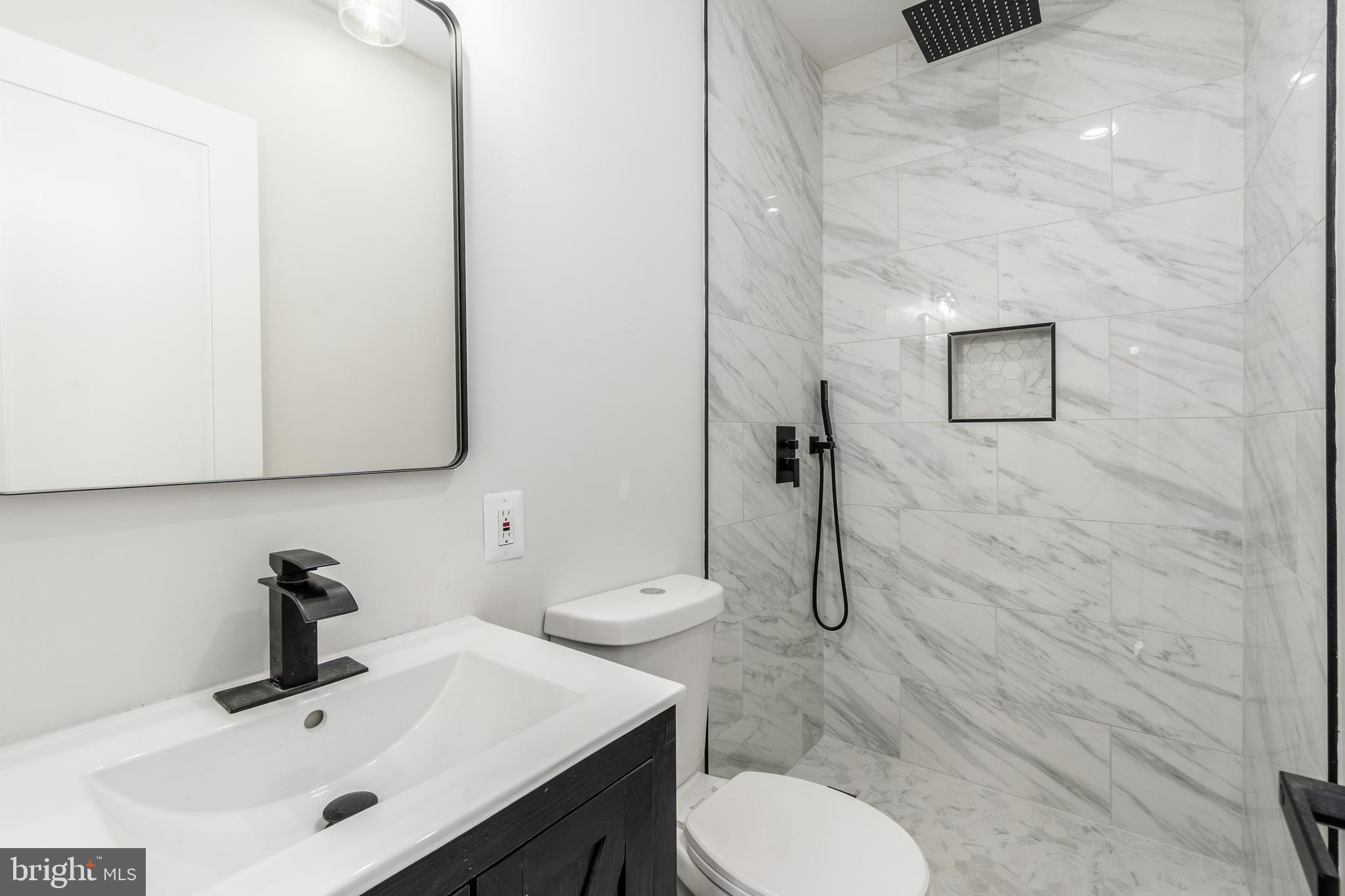 928 Perry Place Northeast Washington, DC 20017 - Photo 20 of 36 a bathroom with a sink toilet and mirror
