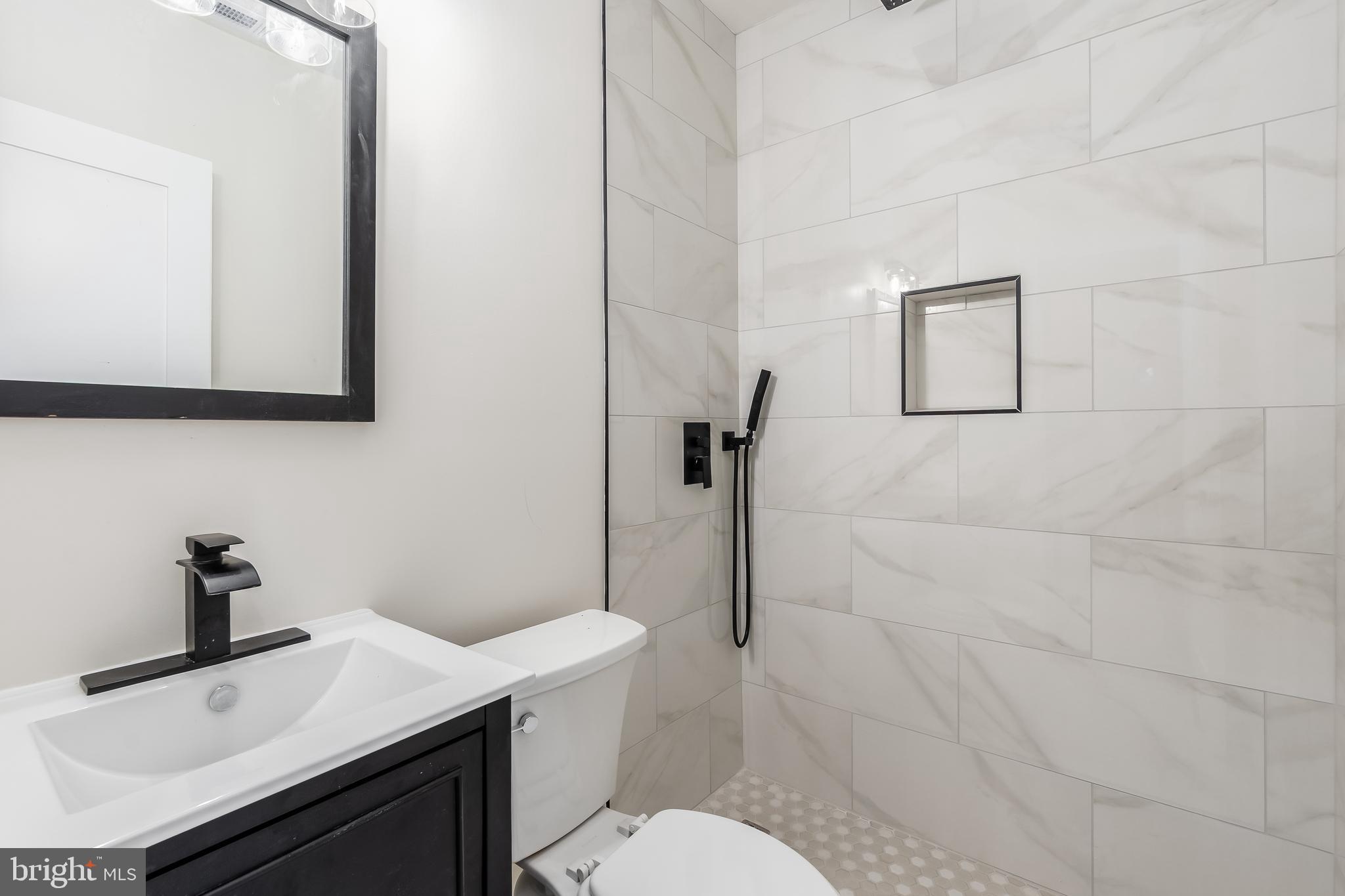 928 Perry Place Northeast Washington, DC 20017 - Photo 21 of 36 a bathroom with a sink toilet and vanity