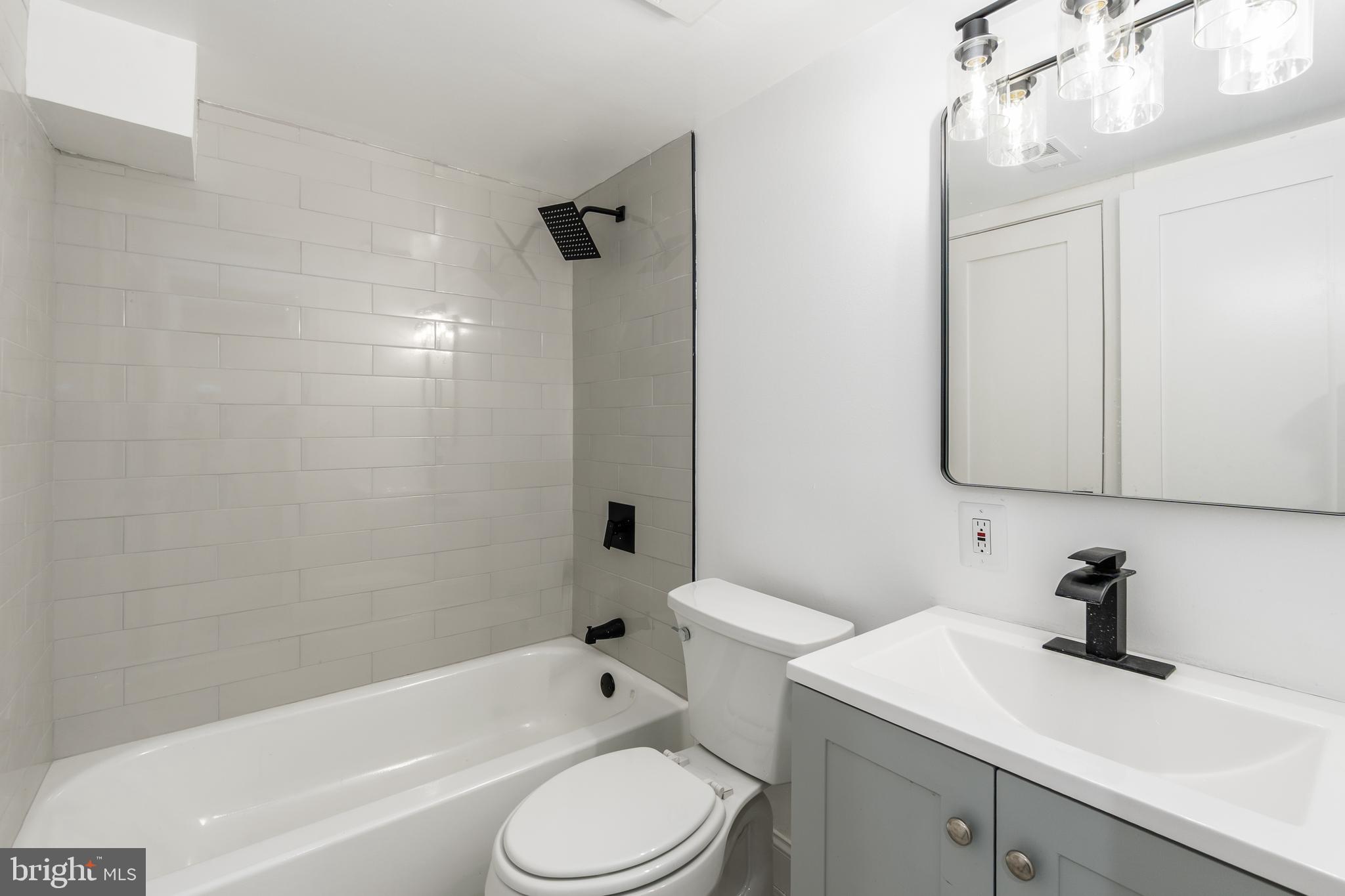 928 Perry Place Northeast Washington, DC 20017 - Photo 28 of 36 a bathroom with a sink a toilet and shower