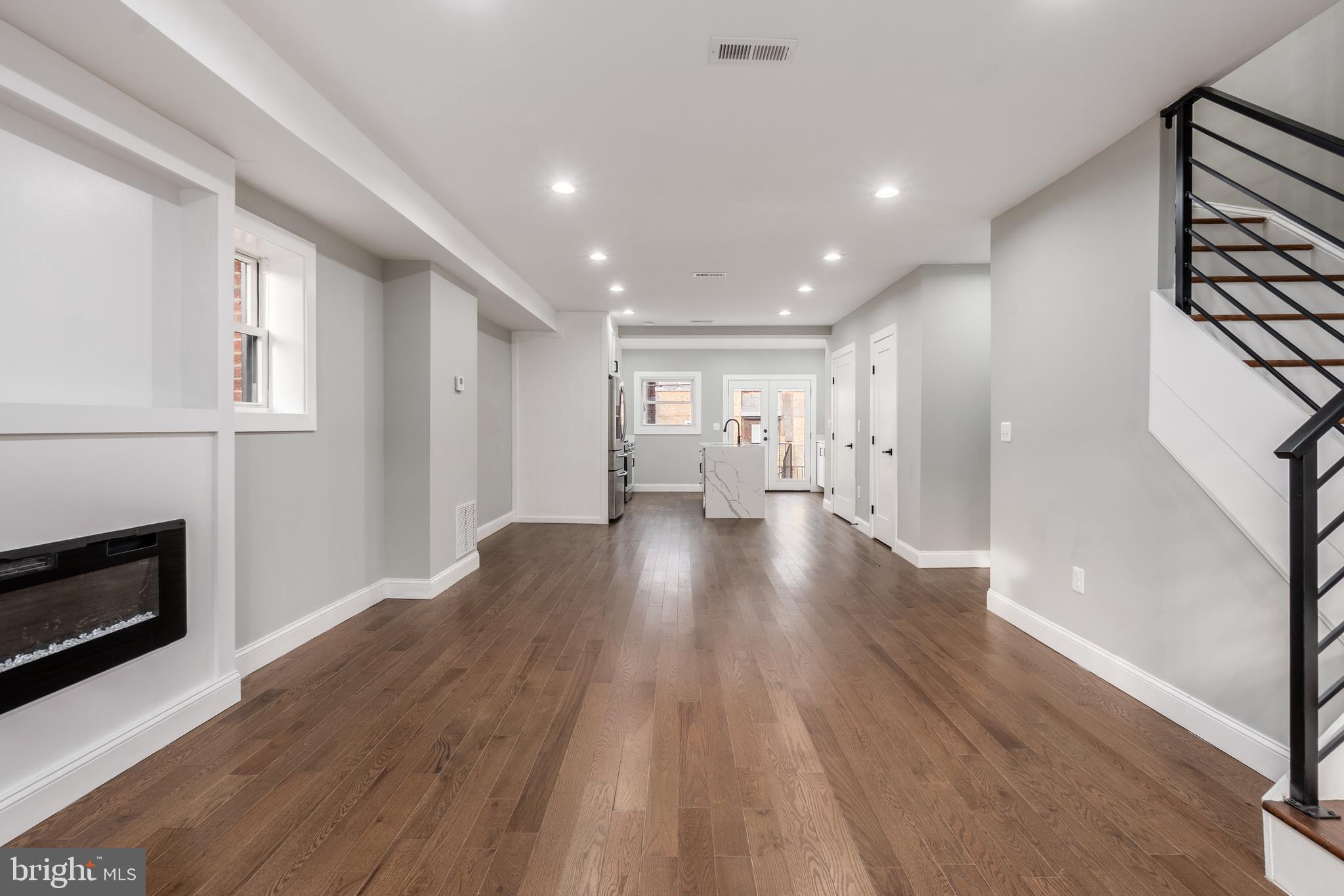 928 Perry Place Northeast Washington, DC 20017 - Photo 5 of 36 a view of empty room with wooden floor and fireplace