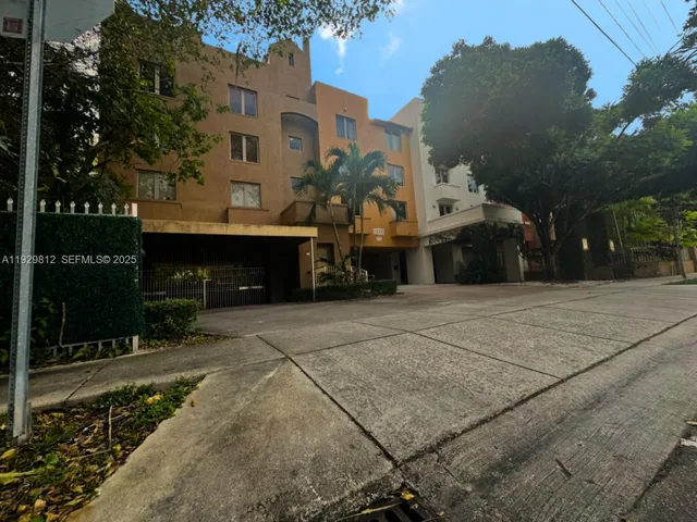 a front view of a building with a yard