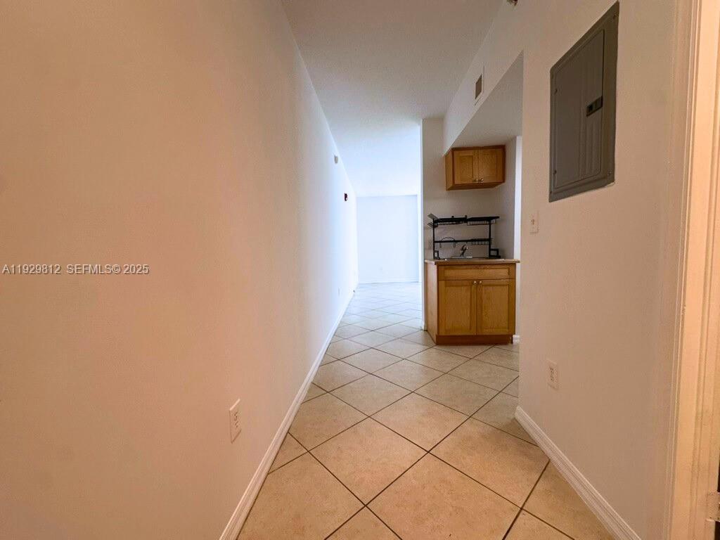 2630 Southwest 28th Street, Unit 44 Miami, FL 33133 - Photo 4 of 12 a kitchen with stainless steel appliances a refrigerator and microwave