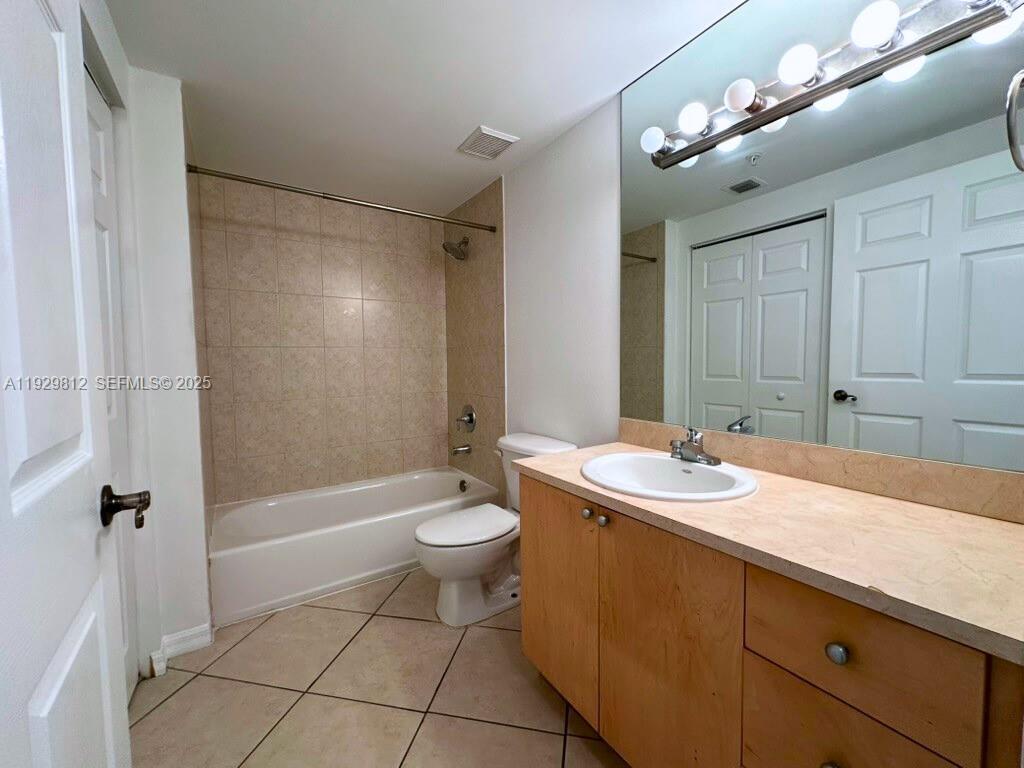 2630 Southwest 28th Street, Unit 44 Miami, FL 33133 - Photo 9 of 12 a bathroom with a sink a toilet a mirror and shower