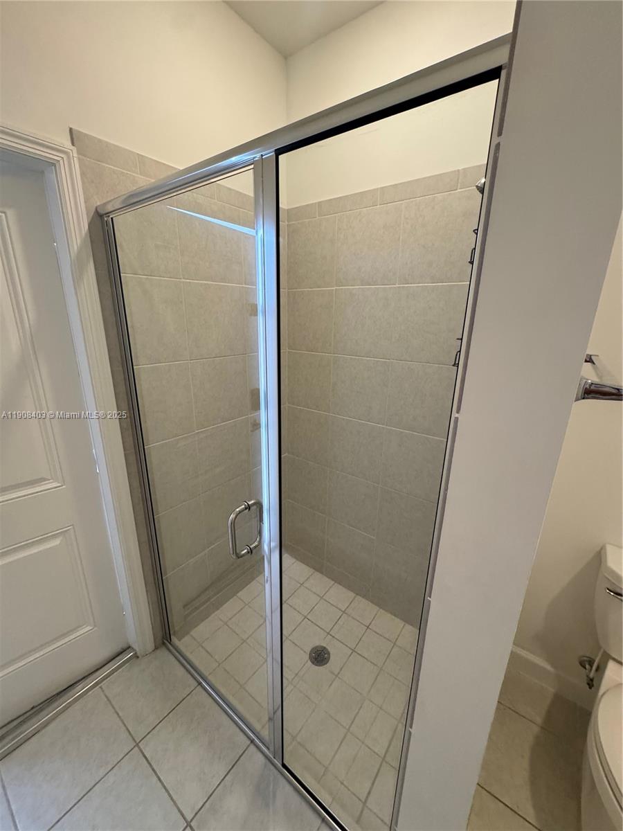 28850 Southwest 163rd Avenue, Unit 2 Homestead, FL 33033 - Photo 7 of 16 a bathroom with a glass shower door