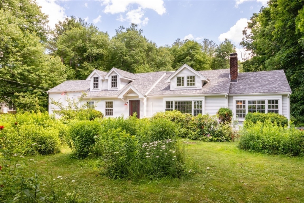 15 Giles Road Lincoln, MA 01773 - Photo 1 of 22 a front view of a house with a garden
