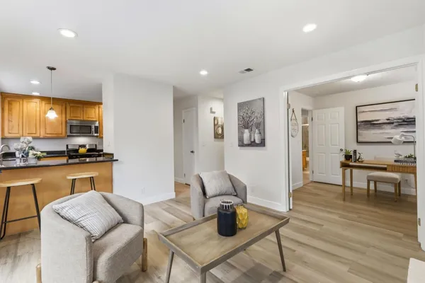 a kitchen with a table chairs refrigerator and cabinets
