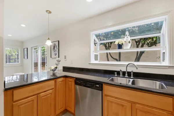 a kitchen with a sink and large window