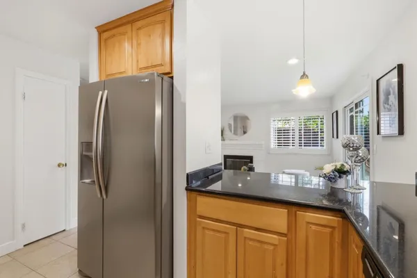 a kitchen with stainless steel appliances granite countertop a refrigerator and a sink