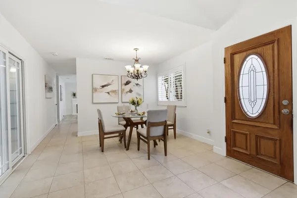 a view of a dining room with furniture and chandelier