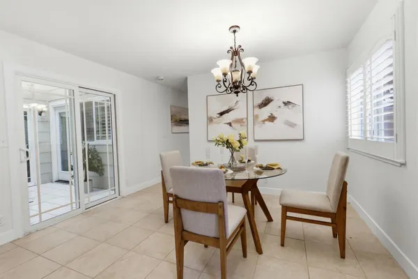 a view of a dining room with furniture wooden floor and chandelier