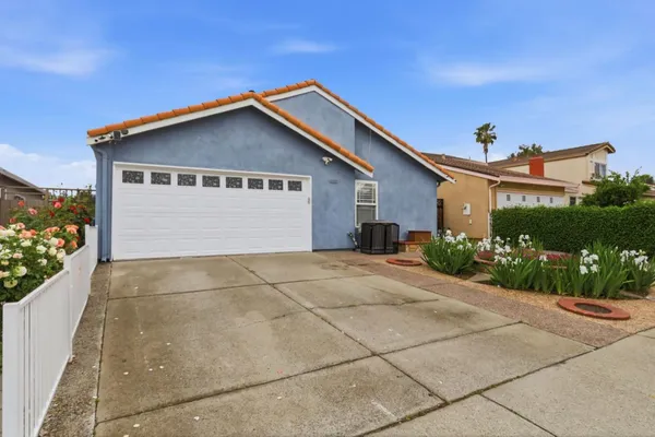 a view of a house with a yard and garage