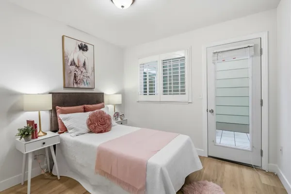 a bedroom with a large bed and a window