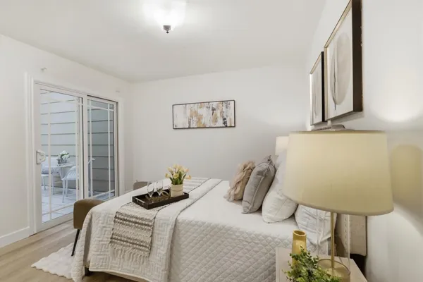 a bedroom with a bed and wooden floor