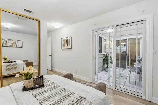 a bedroom with a bed and glass door