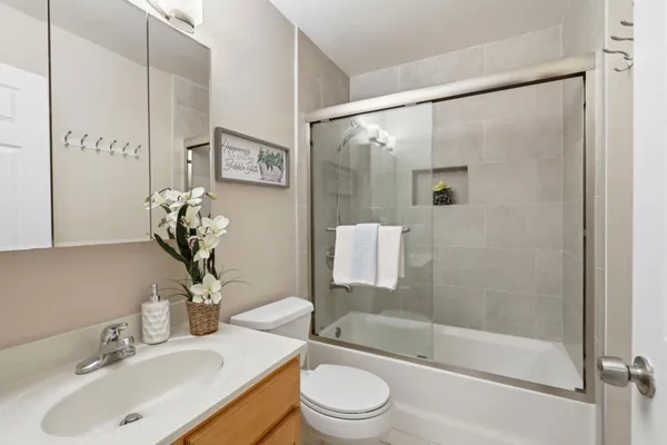 a bathroom with a sink toilet and shower