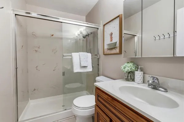 a bathroom with a sink toilet and shower