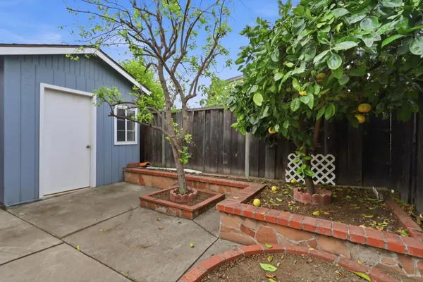 a backyard of a house with table and chairs