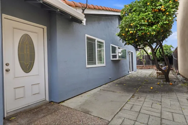 a view of a house with a tree