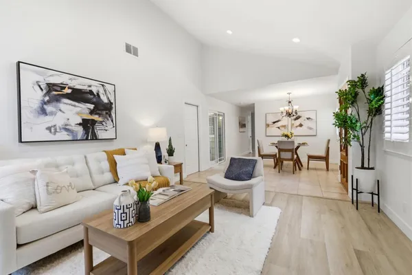 a living room with furniture and a potted plant