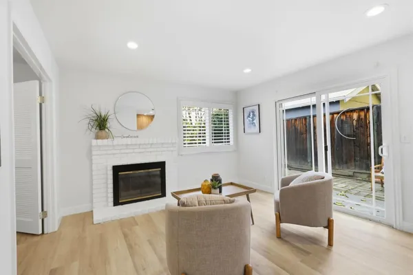 a living room with furniture and a fireplace