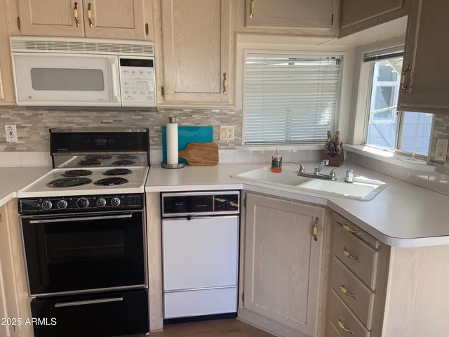 a kitchen with cabinets stainless steel appliances and a sink