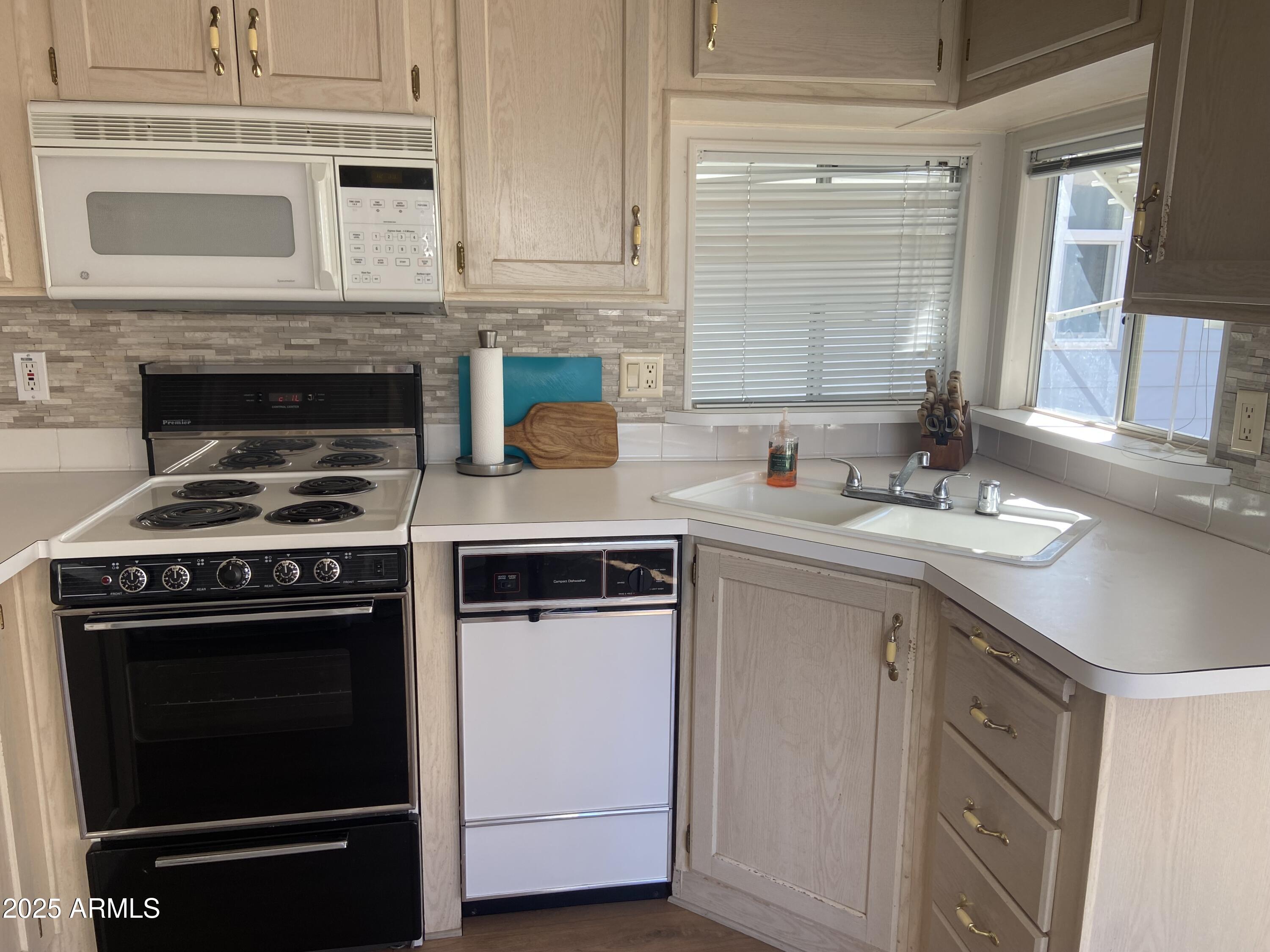 2128 South Dakota Avenue Apache Junction, AZ 85119 - Photo 11 of 36 a kitchen with cabinets stainless steel appliances and a sink