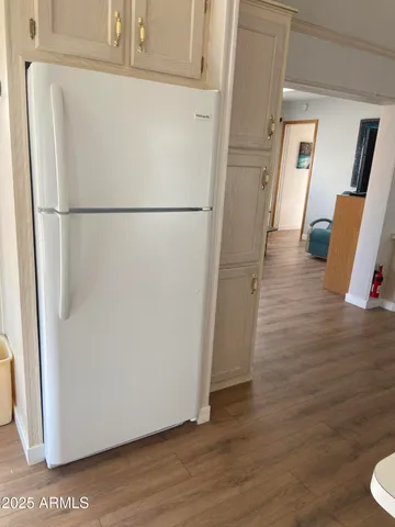 a view of a storage and utility room with wooden floor