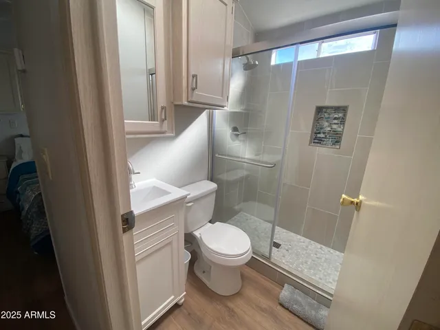 a bathroom with a toilet and a shower