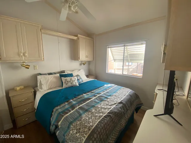 a bed sitting in a bedroom next to a window