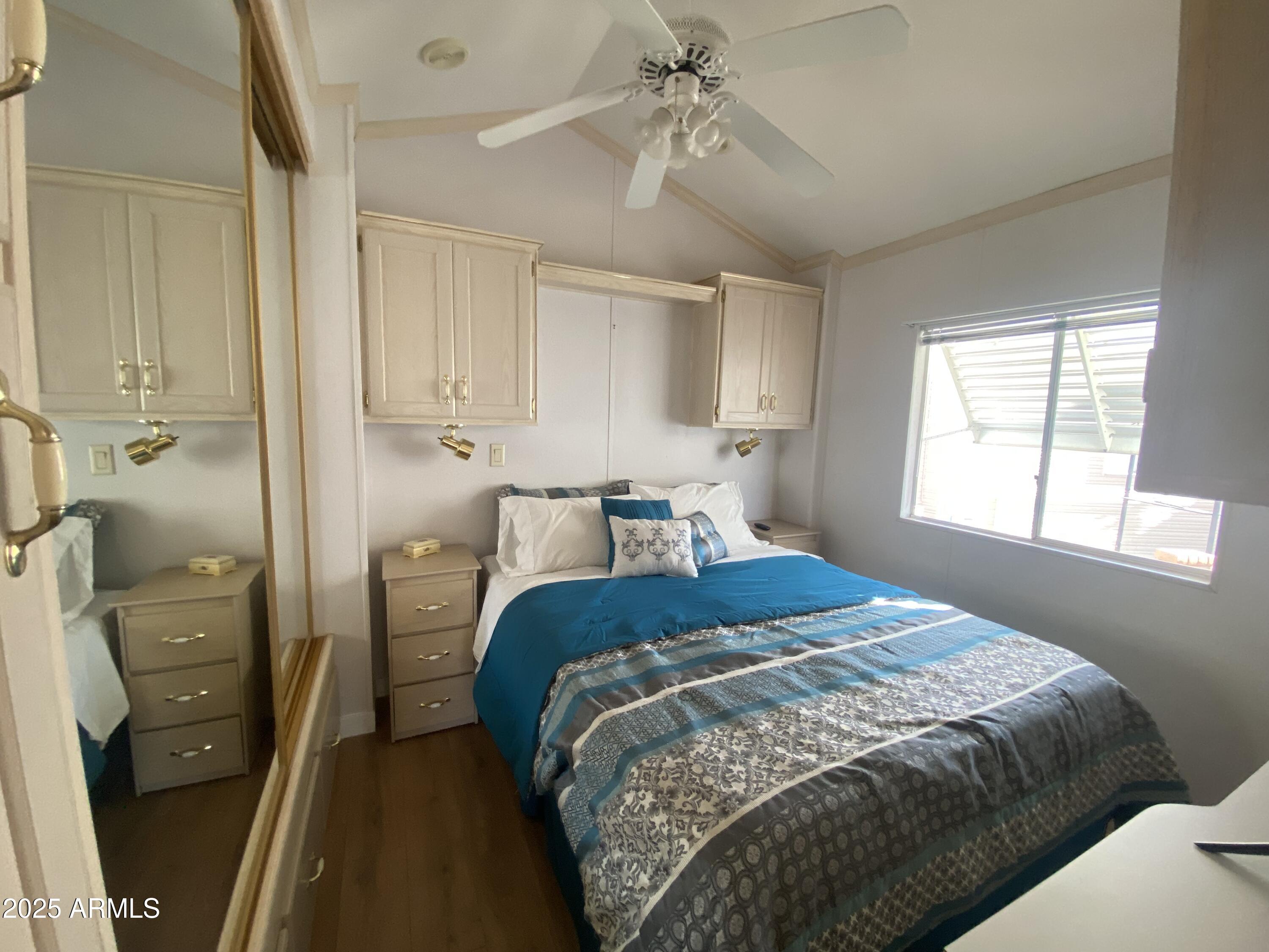 2128 South Dakota Avenue Apache Junction, AZ 85119 - Photo 20 of 36 a bedroom with a bed and a chandelier