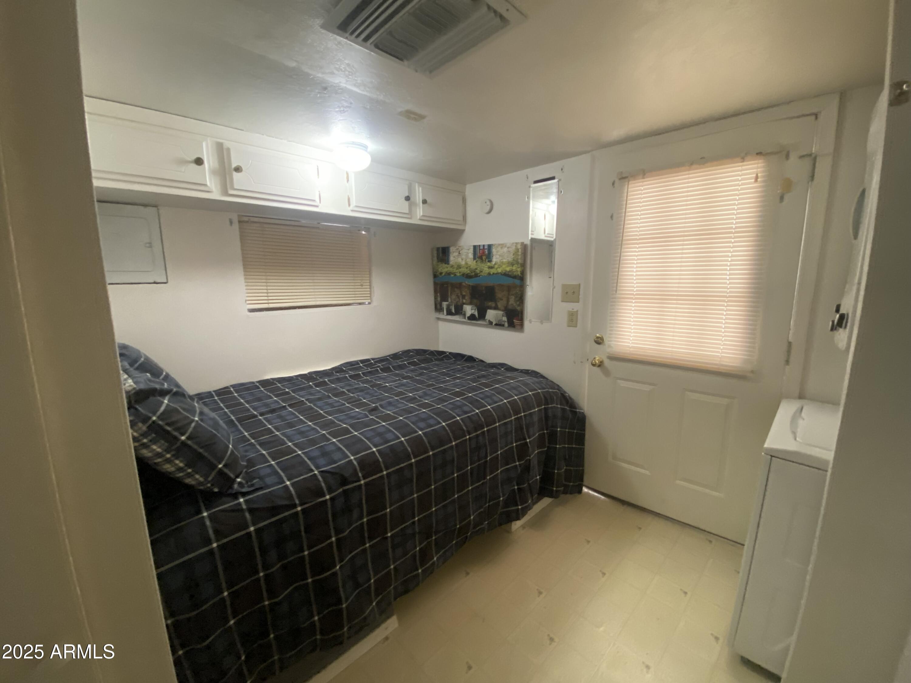 2128 South Dakota Avenue Apache Junction, AZ 85119 - Photo 21 of 36 a bedroom with a bed and a window