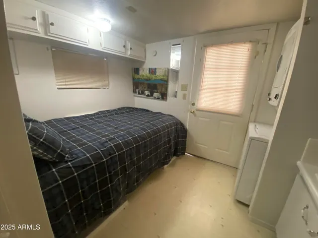 a bedroom with a bed and a window