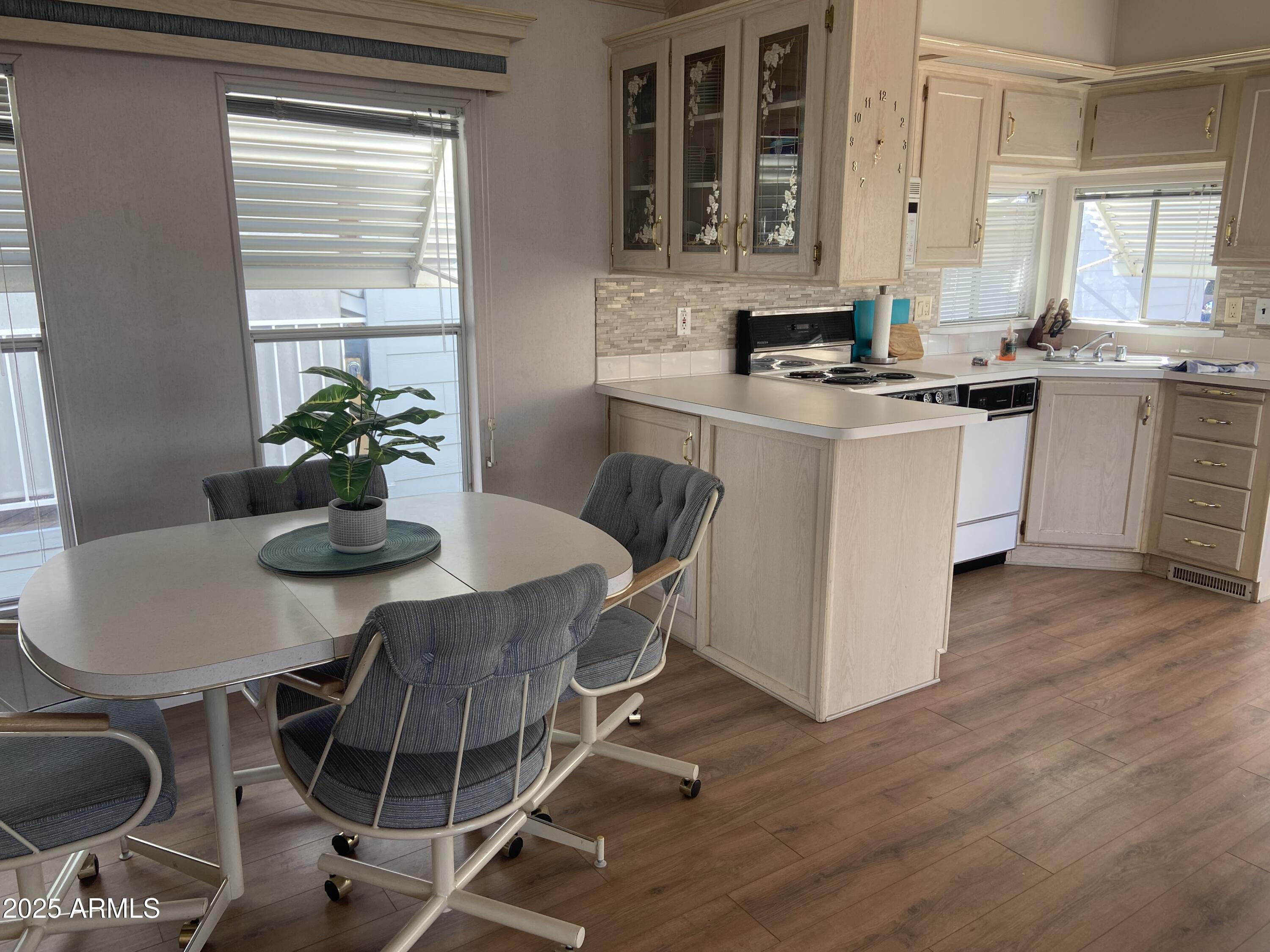 2128 South Dakota Avenue Apache Junction, AZ 85119 - Photo 5 of 36 a kitchen with stainless steel appliances granite countertop a stove a sink a microwave dining table and chairs