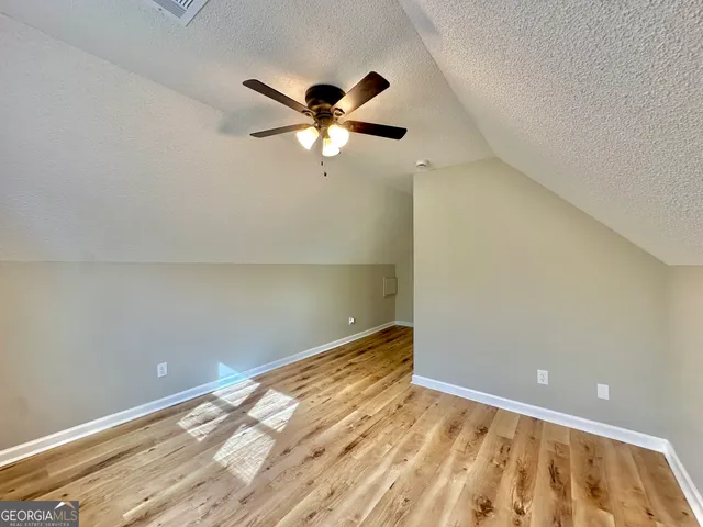 a view of a big room with wooden floor and closet
