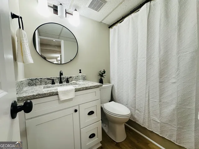 a bathroom with a toilet a sink and a mirror