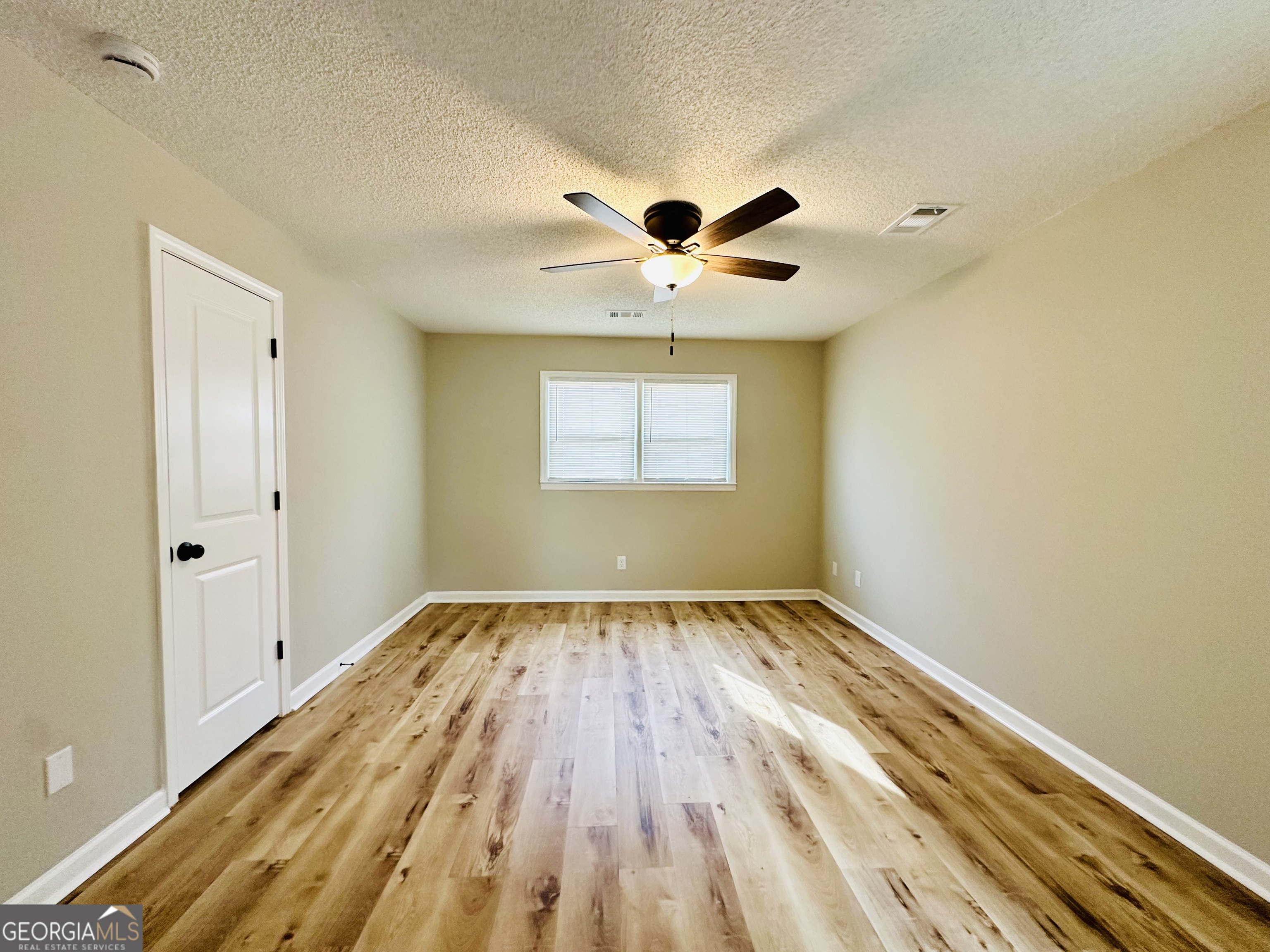 1610 Lance Drive Dublin, GA 31021 - Photo 36 of 46 wooden floor in an empty room with a window