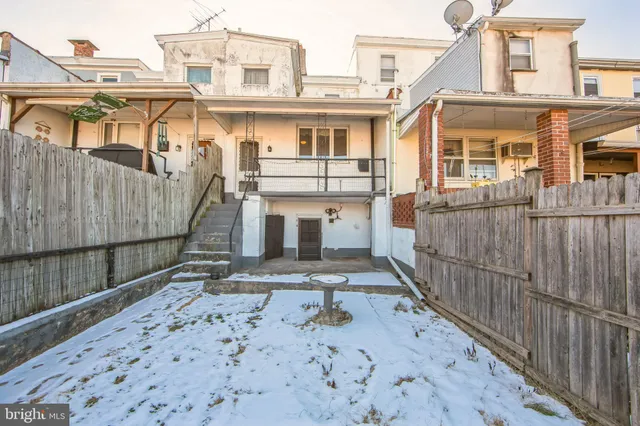 a view of a white building with wooden floor