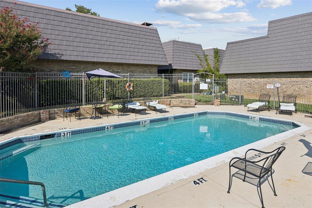 a swimming pool view with a seating space