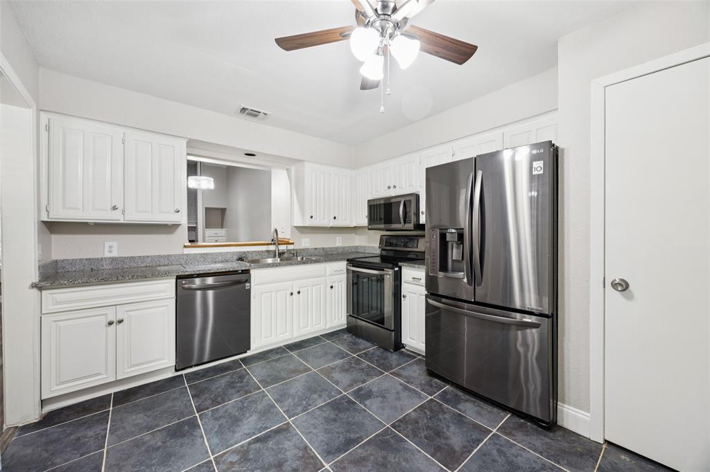 207 East Harwood Road, Unit 14 Euless, TX 76039 - Photo 11 of 28 a kitchen with a refrigerator a sink and dishwasher