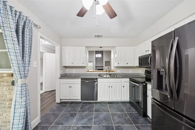 a kitchen with a sink dishwasher a refrigerator and a stove