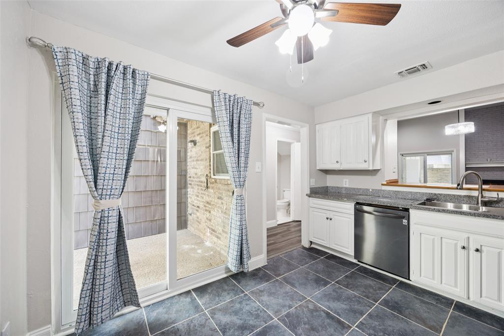 207 East Harwood Road, Unit 14 Euless, TX 76039 - Photo 13 of 28 a kitchen with a sink dishwasher a refrigerator and white cabinets