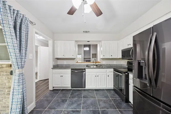 a kitchen with a sink dishwasher a refrigerator and a stove