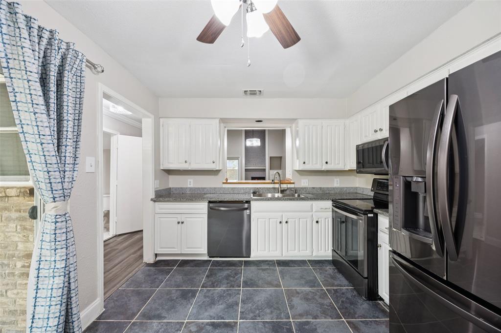 207 East Harwood Road, Unit 14 Euless, TX 76039 - Photo 15 of 28 a kitchen with a sink dishwasher a refrigerator and a stove
